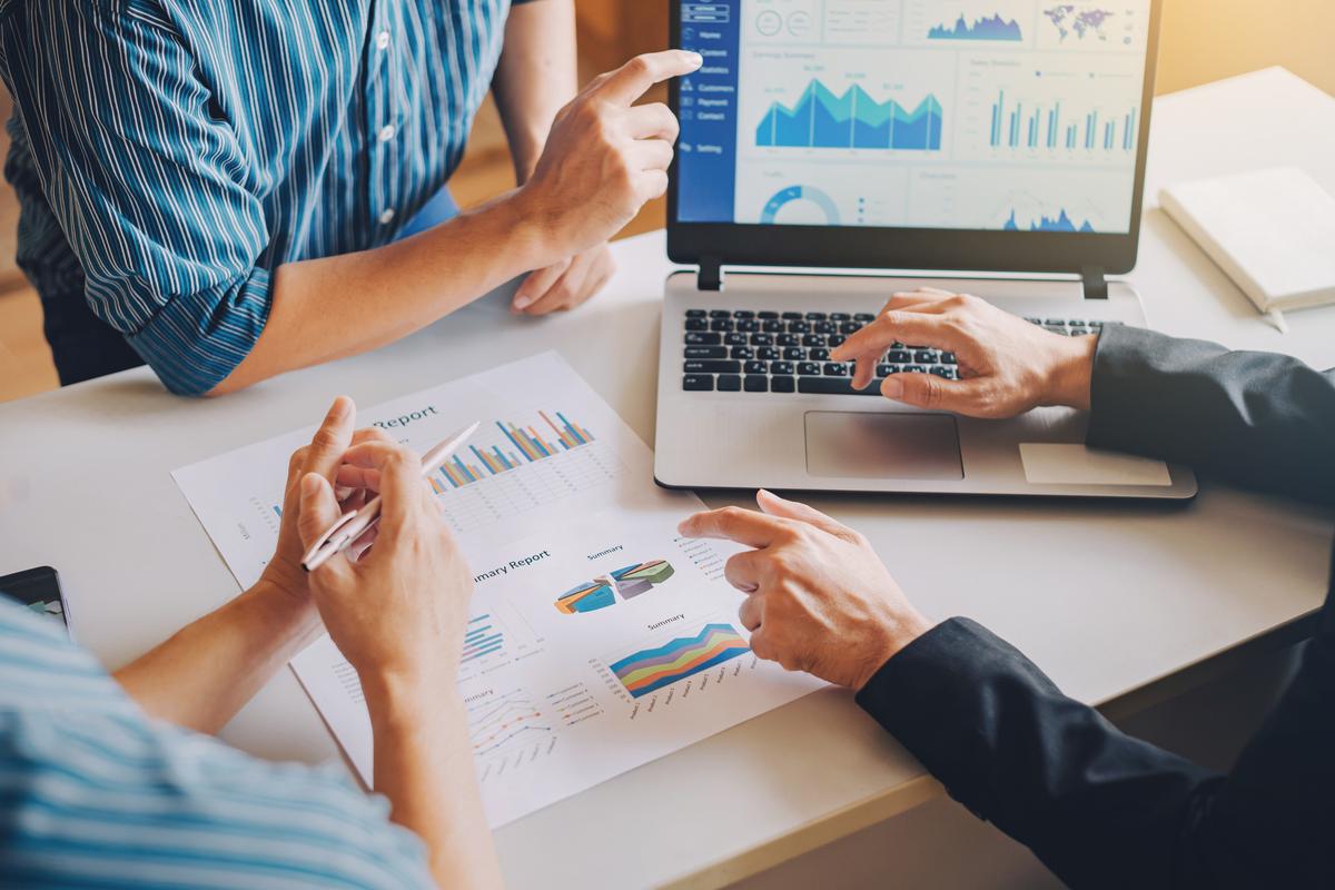 a group of people in a meeting looking at assets